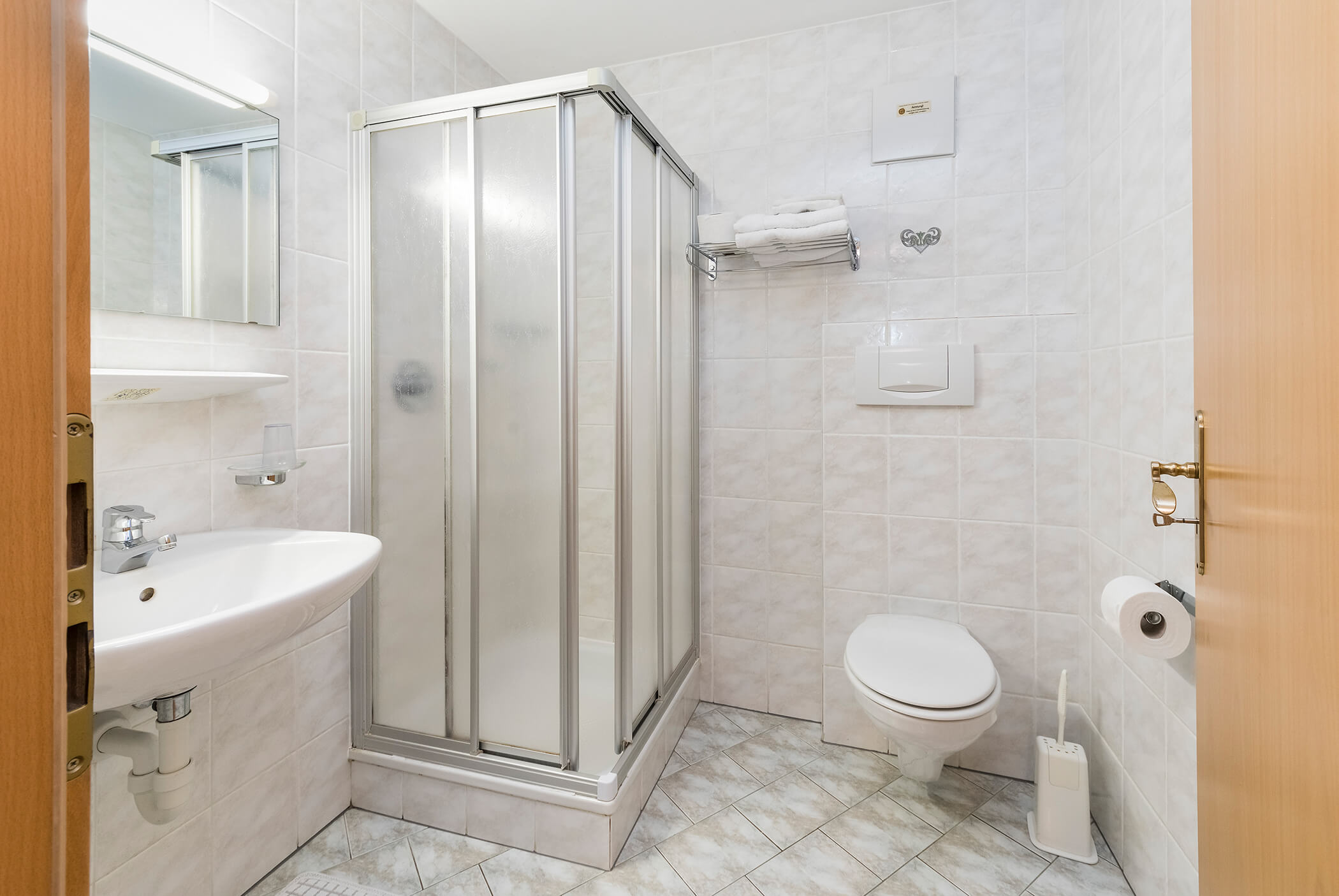 Bright bathroom with shower, WC and washbasin - Schirmerhof