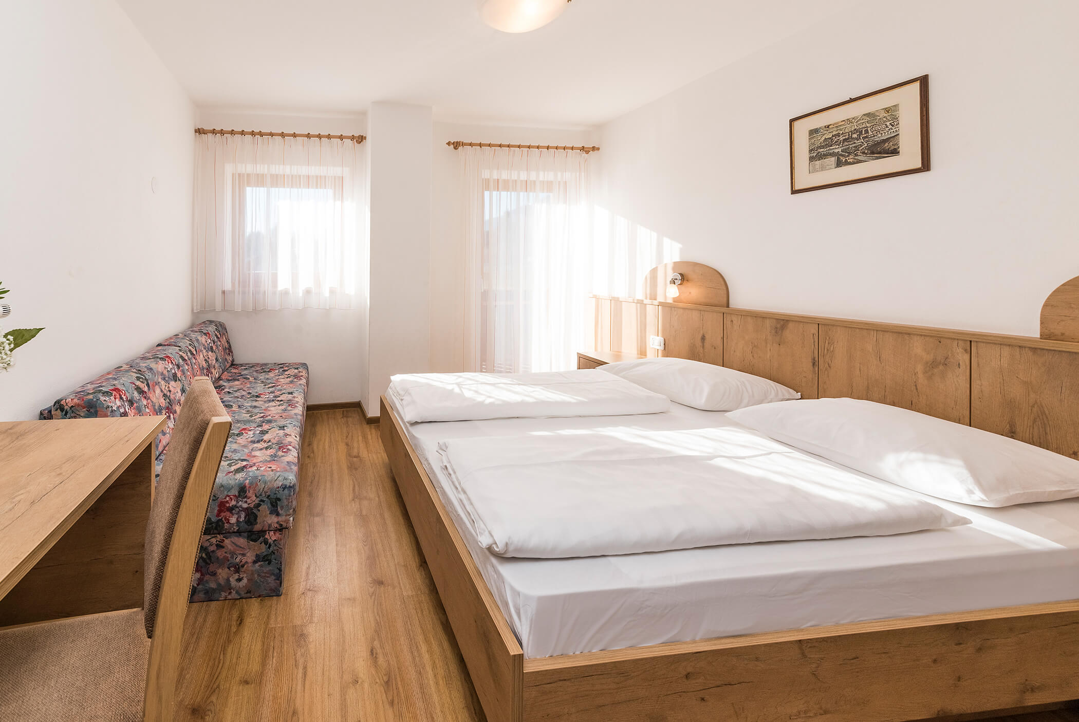 Bedroom with very large double bed and sofa - Schirmerhof