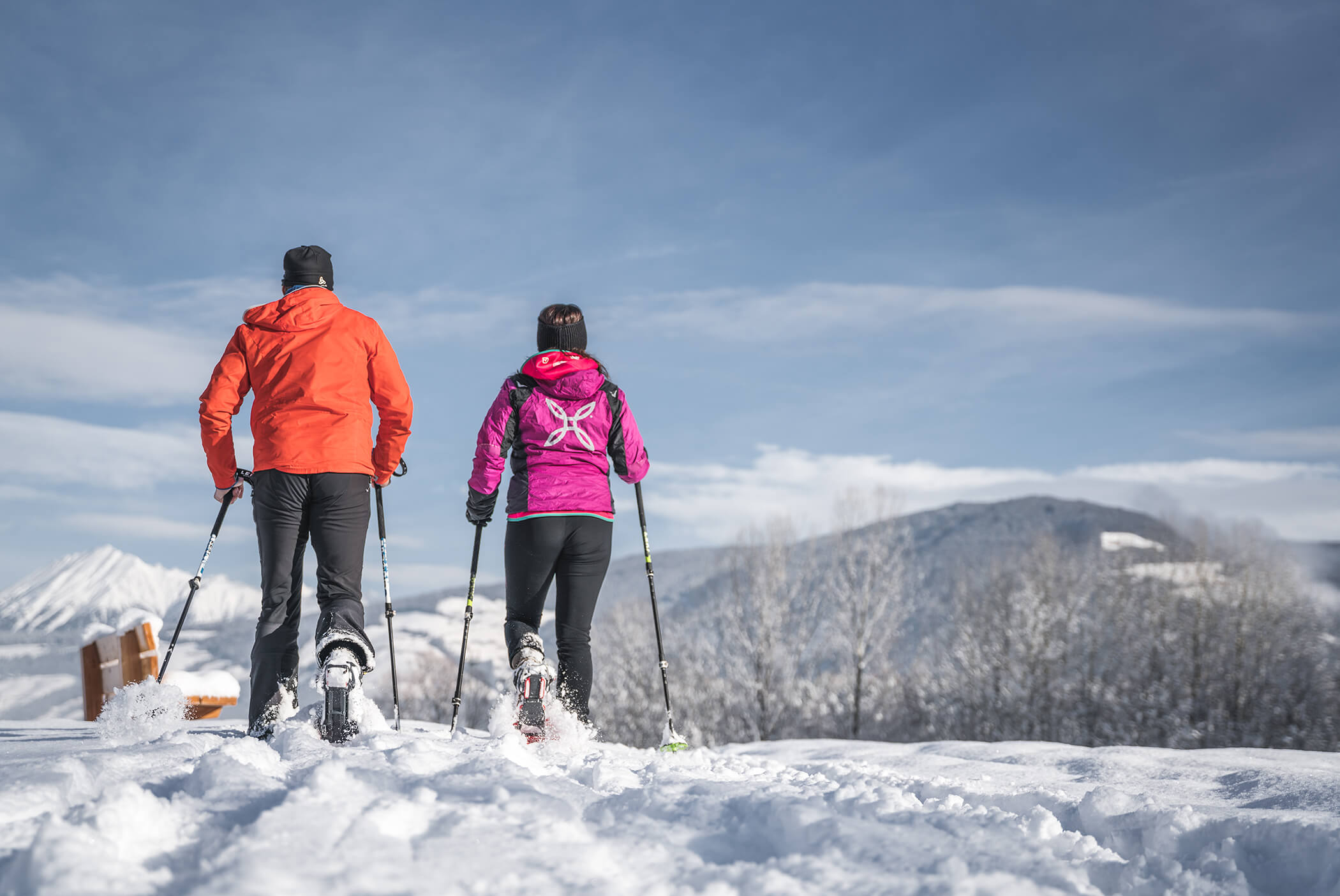 Man and woman ski touring on a snowy meadow - Schirmerhof
