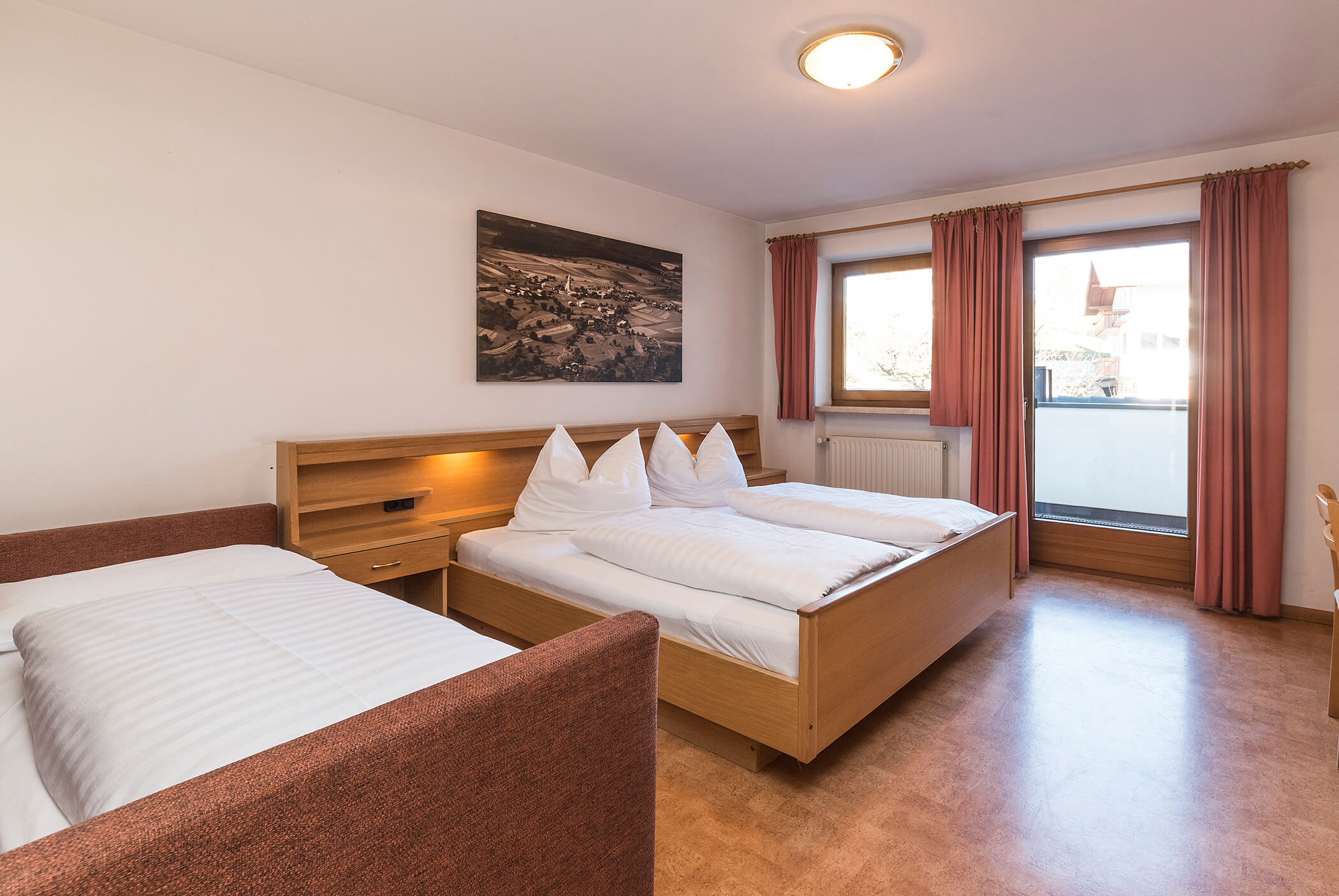 Bedroom with sofa bed, double bed and view of the balcony - Schirmerhof