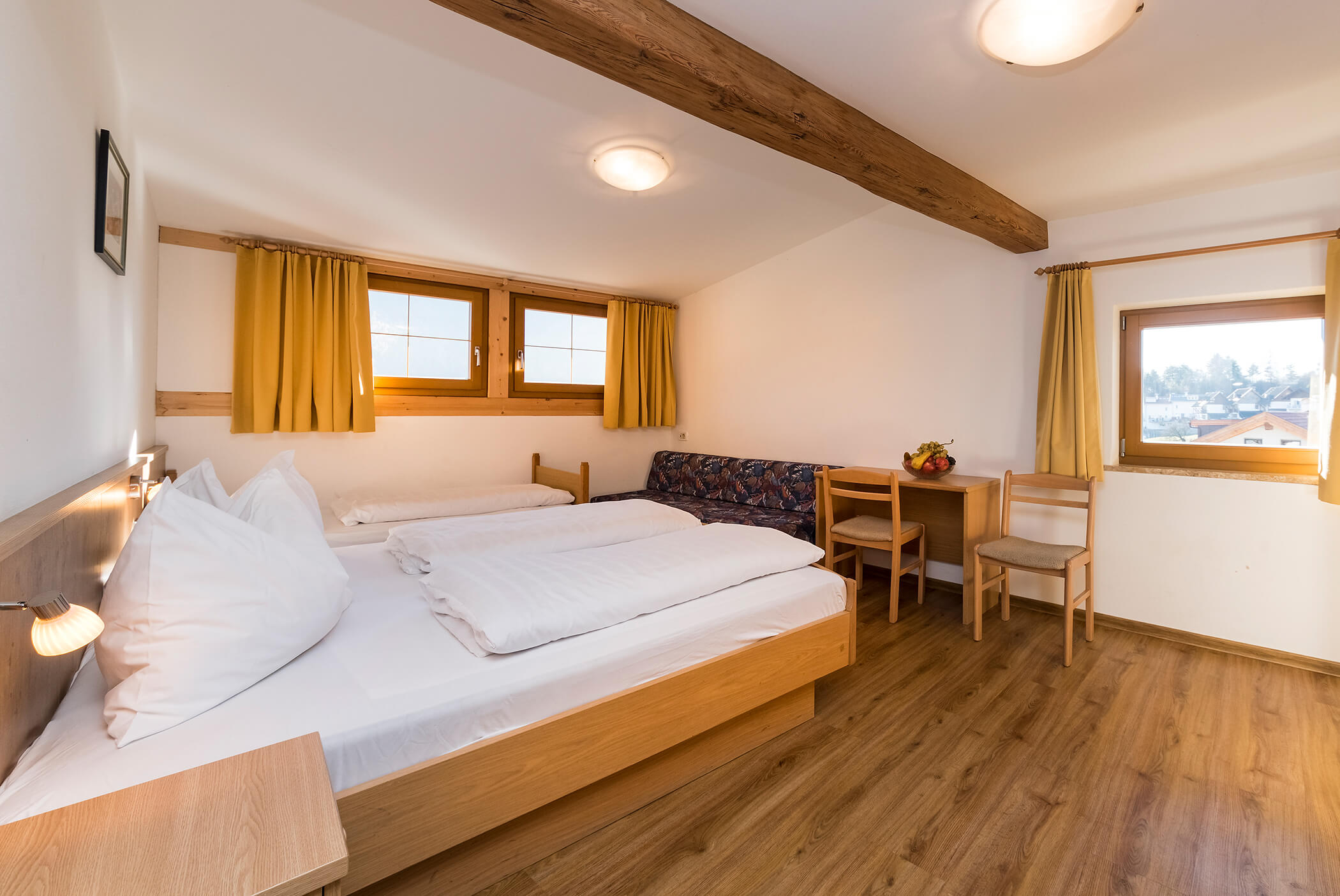 Bedroom with double bed, sofa, table and chairs - Schirmerhof